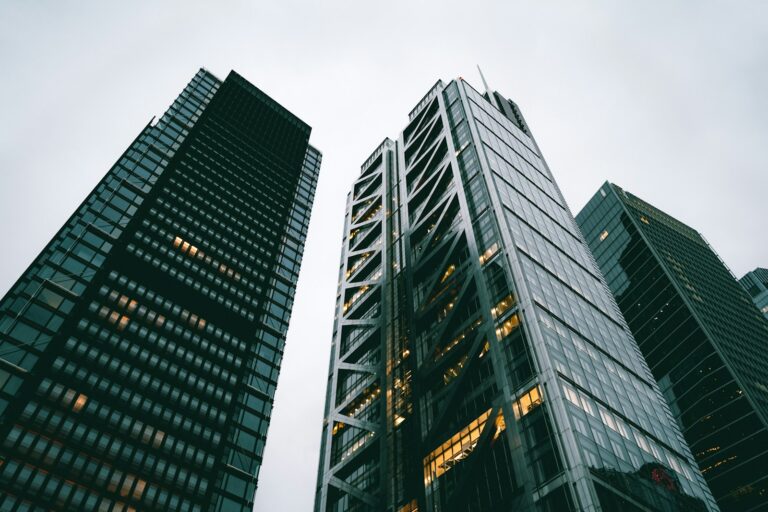 a couple of tall buildings sitting next to each other